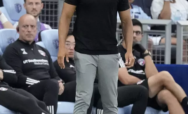 FC Dallas head coach Peter Luccin watches during the first half of an MLS soccer Sporting Kansas City Sunday, July 7, 2024, in Kansas City, Kan. (AP Photo/Charlie Riedel)