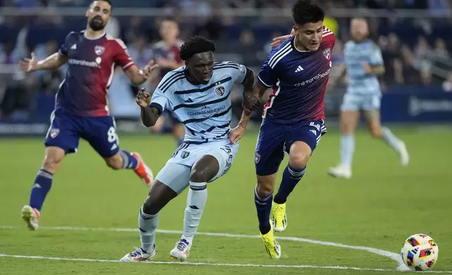 Sporting Kansas City attacker Stephen Afrifa (30) and FC Dallas defender Marco Farfan (4) chase after the ball during the second half of an MLS soccer match Sunday, July 7, 2024, in Kansas City, Kan. Sporting Kansas City won 3-2. (AP Photo/Charlie Riedel)