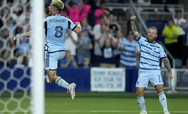 Sporting Kansas City midfielder Memo Rodríguez (8) celebrates after scoring a goal during the second half of an MLS soccer match against FC DallasSunday, July 7, 2024, in Kansas City, Kan. Sporting Kansas City won 3-2. (AP Photo/Charlie Riedel)