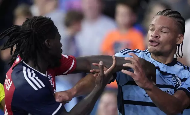 Sporting Kansas City defender Zorhan Bassong, right, and FC Dallas defender Ema Twumasi, left, scuffle during the second half of an MLS soccer match Sunday, July 7, 2024, in Kansas City, Kan. Sporting Kansas City won 3-2. (AP Photo/Charlie Riedel)