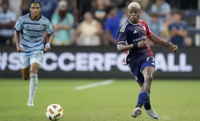 FC Dallas midfielder Bernard Kamungo kicks the ball during the first half of an MLS soccer match against Sporting Kansas City Sunday, July 7, 2024, in Kansas City, Kan. (AP Photo/Charlie Riedel)