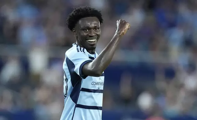 Sporting Kansas City attacker Stephen Afrifa celebrates after a goal by midfielder Memo Rodríguez (8) during the second half of an MLS soccer match against FC Dallas Sunday, July 7, 2024, in Kansas City, Kan. Sporting Kansas City won 3-2. (AP Photo/Charlie Riedel)