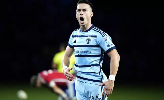 Sporting Kansas City midfielder Erik Thommy (26) celebrates after a goal by midfielder Memo Rodríguez (8) during the second half of an MLS soccer match against FC Dallas Sunday, July 7, 2024, in Kansas City, Kan. Sporting Kansas City won 3-2. (AP Photo/Charlie Riedel)