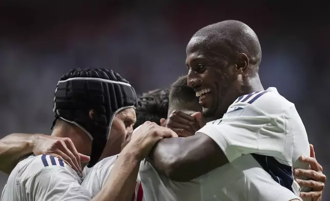 Vancouver Whitecaps' Fafa Picault, right, Bjorn Inge Utvik, left, and Ranko Veselinovic, front center, celebrate Veselinovic's goal against the Houston Dynamo during the second half of an MLS soccer match in Vancouver, British Columbia, Saturday, July 20, 2024. (Darryl Dyck/The Canadian Press via AP)