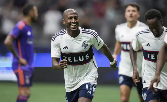 Vancouver Whitecaps' Fafa Picault (11) celebrates his goal against the Houston Dynamo during the second half of an MLS soccer match in Vancouver, British Columbia, Saturday, July 20, 2024. (Darryl Dyck/The Canadian Press via AP)