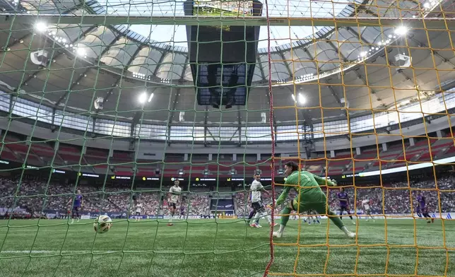 Vancouver Whitecaps goalkeeper Yohei Takaoka (1) allows a goal to Houston Dynamo's Adalberto Carrasquilla, during the first half of an MLS soccer match in Vancouver, British Columbia, Saturday, July 20, 2024. (Darryl Dyck/The Canadian Press via AP)