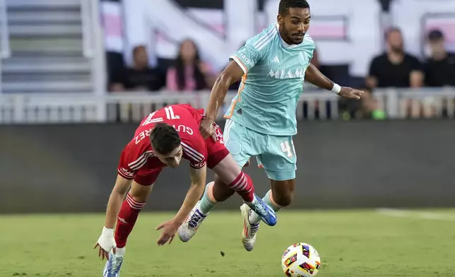 Chicago Fire midfielder Brian Gutiérrez (17) falls as he goes for the ball against Inter Miami midfielder Yannick Bright, right, during the first half of an MLS soccer match, Saturday, July 20, 2024, in Fort Lauderdale, Fla. (AP Photo/Lynne Sladky)