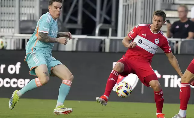 Chicago Fire defender Arnaud Souquet, right, controls the ball as Inter Miami midfielder Robert Taylor, left, defends during the first half of an MLS soccer match, Saturday, July 20, 2024, in Fort Lauderdale, Fla. (AP Photo/Lynne Sladky)