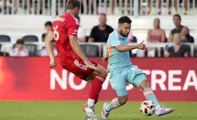 Inter Miami defends Jordi Alba, right, runs with the ball as Chicago Fire defender Wyatt Omsberg, left, defends during the first half of an MLS soccer match, Saturday, July 20, 2024, in Fort Lauderdale, Fla. (AP Photo/Lynne Sladky)