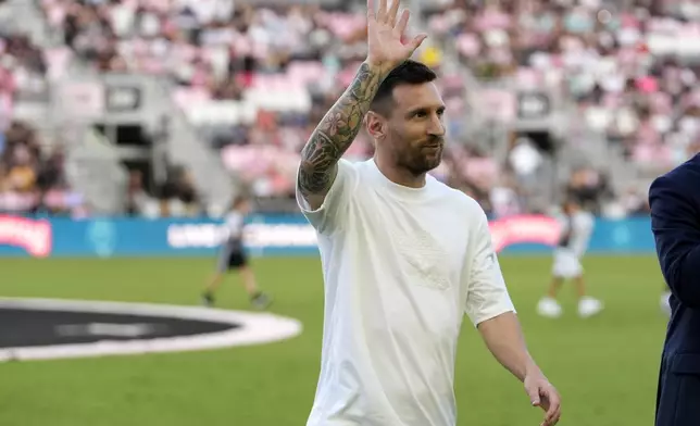 Inter Miami forward Lionel Messi waves as he walks off the field after being honored for his 45 career trophies before an MLS soccer match against the Chicago Fire, Saturday, July 20, 2024, in Fort Lauderdale, Fla. (AP Photo/Lynne Sladky)