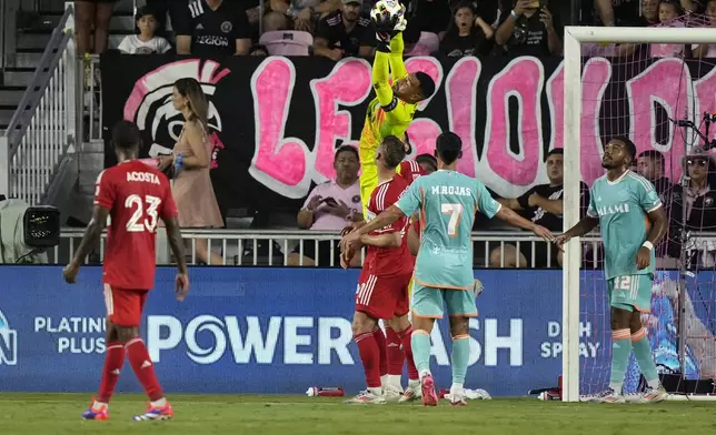 Inter Miami goalkeeper Drake Callender, center top, makes a save during the first half of an MLS soccer match against Chicago Fire, Saturday, July 20, 2024, in Fort Lauderdale, Fla. (AP Photo/Lynne Sladky)