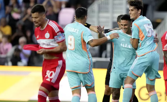 Inter Miami midfielder Matías Rojas, csecond from right, celebrates with forward Luis Suárez (9) and midfielder Federico Redondo (55) after scoring during the first half of an MLS soccer match against the Chicago Fire, Saturday, July 20, 2024, in Fort Lauderdale, Fla. (AP Photo/Lynne Sladky)