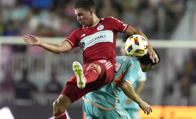 Chicago Fire defender Arnaud Souquet, left, goes for the ball against Inter Miami forward Leo Afonso, right, during the second half of an MLS soccer match, Saturday, July 20, 2024, in Fort Lauderdale, Fla. (AP Photo/Lynne Sladky)