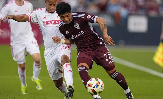 St. Louis City defender Akil Watts, second from left, battles for control of the ball with Colorado Rapids midfielder Omir Fernandez in the first half of a MLS soccer match Sunday, July 7, 2024, in Commerce City, Colo. (AP Photo/David Zalubowski)