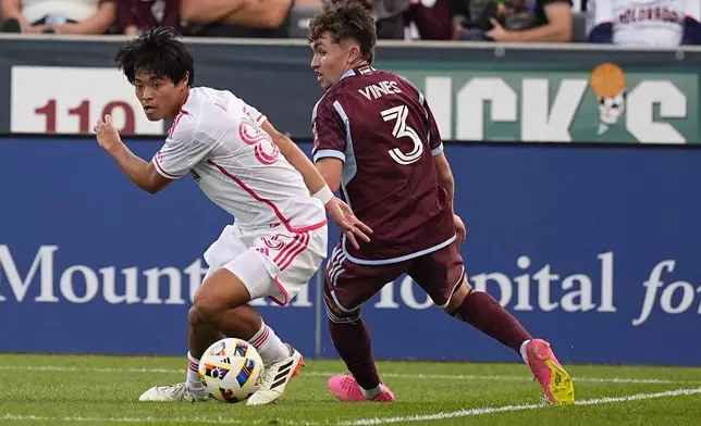 St. Louis City midfielder Hosei Kijima, left, battles for control of the ball with Colorado Rapids defender Sam Vines in the first half of a soccer match Sunday, July 7, 2024, in Commerce City, Colo. (AP Photo/David Zalubowski)