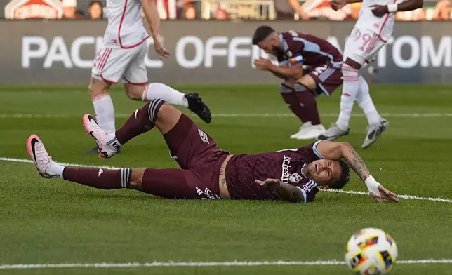 Colorado Rapids forward Rafael Navarro falls after missing a pass on the side of the net of St. Louis City in the first half of a MLS soccer match Sunday, July 7, 2024, in Commerce City, Colo. (AP Photo/David Zalubowski)