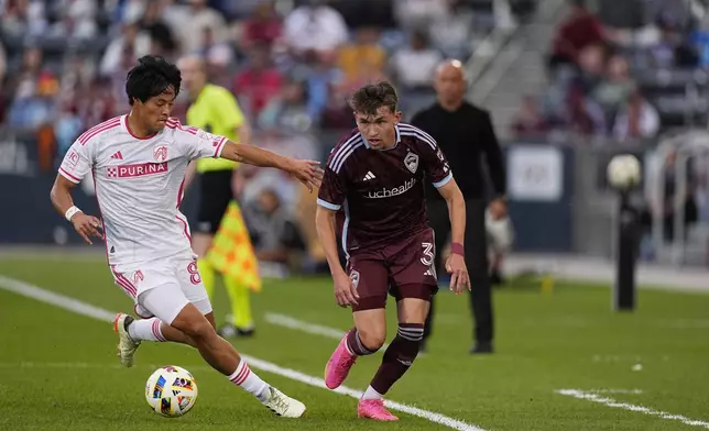 St. Louis City midfielder Hosei Kijima, left, battles for the ball with Colorado Rapids defender Sam Vines in the first half of a MLS soccer match Sunday, July 7, 2024, in Commerce City, Colo. (AP Photo/David Zalubowski)