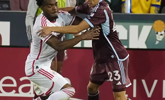 St. Louis City defender Jayden Reid, left, jostles with Colorado Rapids midfielder Cole Bassett for control of the ball in the second half of a MLS soccer match Sunday, July 7, 2024, in Commerce City, Colo. (AP Photo/David Zalubowski)