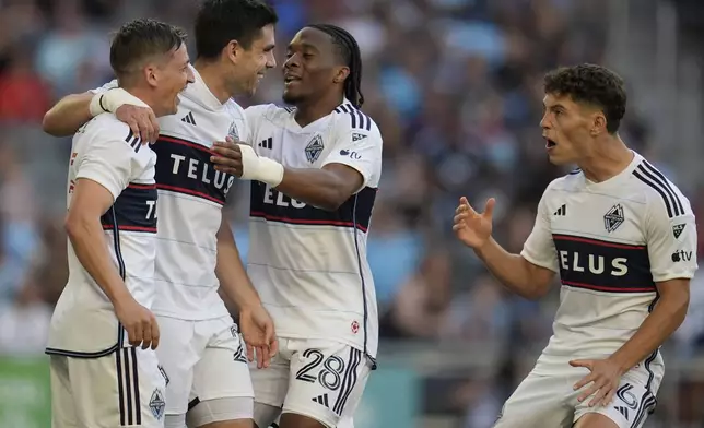 Vancouver Whitecaps forward Brian White, second left, celebrates with teammates after scoring during the first half of an MLS soccer match against Minnesota United in St. Paul, Minn., Wednesday, July 3, 2024. (AP Photo/Abbie Parr)