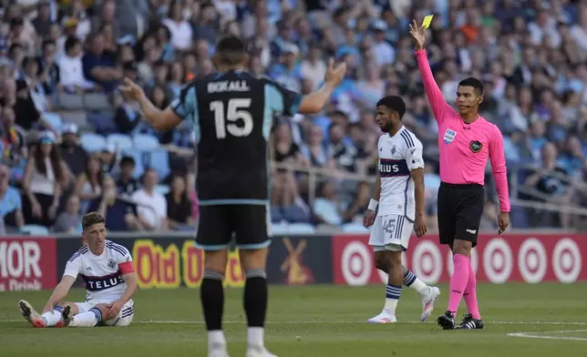 A yellow card is issued to Minnesota United forward Jeong Sang-Bin (not pictured) during the first half of an MLS soccer match against the Vancouver Whitecaps in St. Paul, Minn., Wednesday, July 3, 2024. (AP Photo/Abbie Parr)