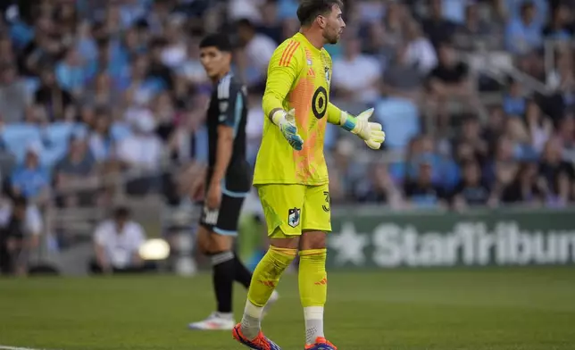 Minnesota United goalkeeper Alec Smir, front, reacts after the second goal scored by the Vancouver Whitecaps during the first half of an MLS soccer match in St. Paul, Minn., Wednesday, July 3, 2024. (AP Photo/Abbie Parr)