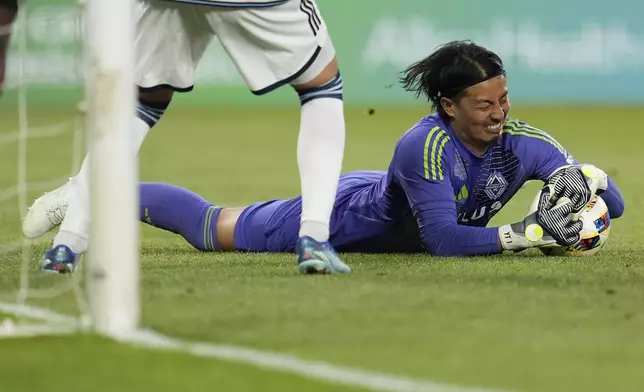 Vancouver Whitecaps goalkeeper Yohei Takaoka stops a shot during the second half of an MLS soccer match against Minnesota United in St. Paul, Minn., Wednesday, July 3, 2024. (AP Photo/Abbie Parr)