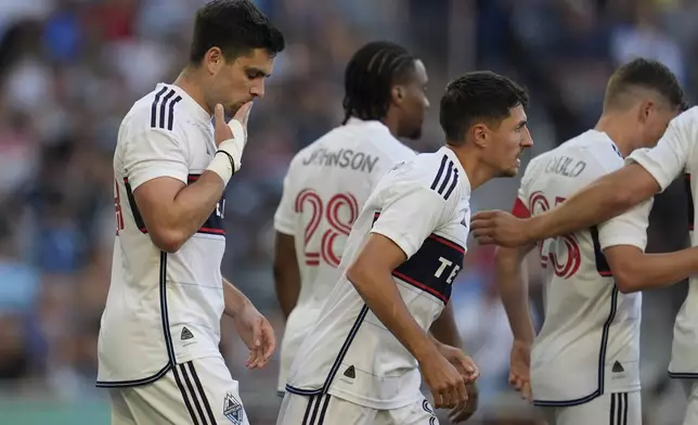 Vancouver Whitecaps forward Brian White, left, celebrates after scoring during the first half of an MLS soccer match against Minnesota United in St. Paul, Minn., Wednesday, July 3, 2024. (AP Photo/Abbie Parr)