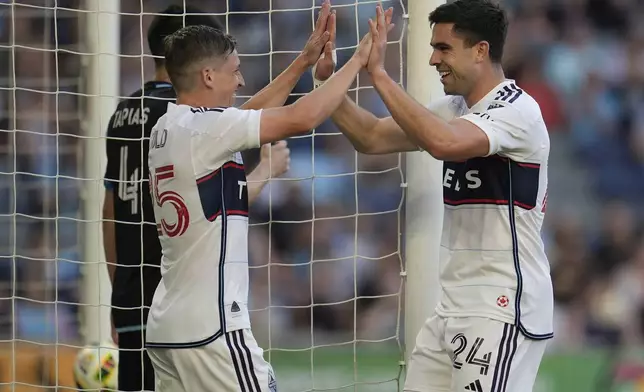Vancouver Whitecaps forward Brian White (24) celebrates with midfielder Ryan Gauld (25) after scoring a goal during the first half of an MLS soccer match against Minnesota United in St. Paul, Minn., Wednesday, July 3, 2024. (AP Photo/Abbie Parr)
