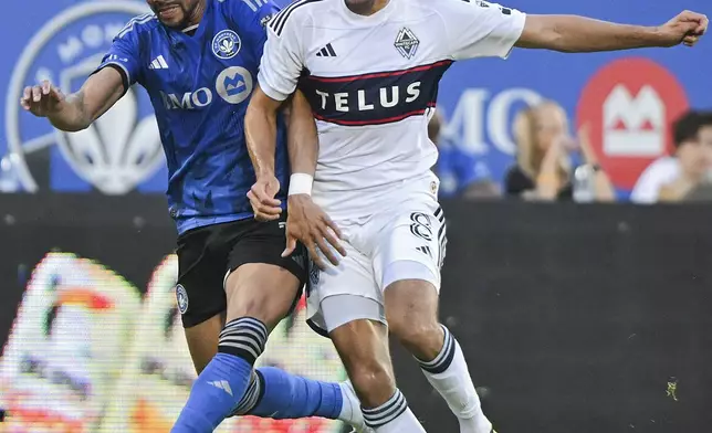 CF Montreal's Ariel Lassiter, left, challenges Vancouver Whitecaps' Alessandro Schopf (8) during the first half of a MLS soccer game in Montreal, Saturday, July 6, 2024. (Graham Hughes/The Canadian Press via AP)