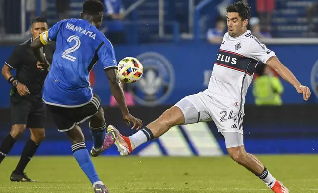 Vancouver Whitecaps' Brian White (24) challenges CF Montreal's Victor Wanyama (2) during the second half of a MLS soccer game in Montreal, Saturday, July 6, 2024. (Graham Hughes/The Canadian Press via AP)