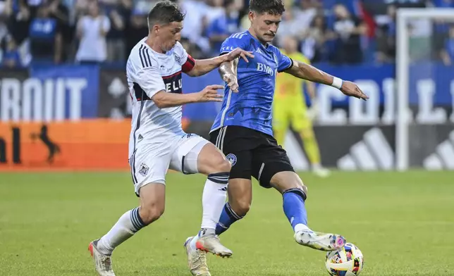 Vancouver Whitecaps' Ryan Gauld, left, challenges CF Montreal's Joaquin Sosa (3) during the first half of an MLS soccer game in Montreal, Saturday, July 6, 2024. (Graham Hughes/The Canadian Press via AP)