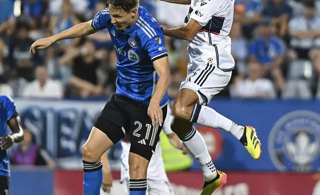 Vancouver Whitecaps's Alessandro Schopf (8) and CF Montreal's Lassi Lappalainen (21) go up for the ball during the second half of a MLS soccer game in Montreal, Saturday, July 6, 2024. (Graham Hughes/The Canadian Press via AP)