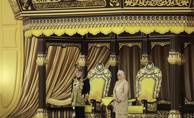 The 17th King of Malaysia, Sultan Ibrahim Iskandar, left, and Queen Raja Zarith Sofiah stand next to the thrones during his coronation at the National Palace in Kuala Lumpur, Malaysia, Saturday, July 20, 2024. (Hasnoor Hussain/Pool Photo via AP)