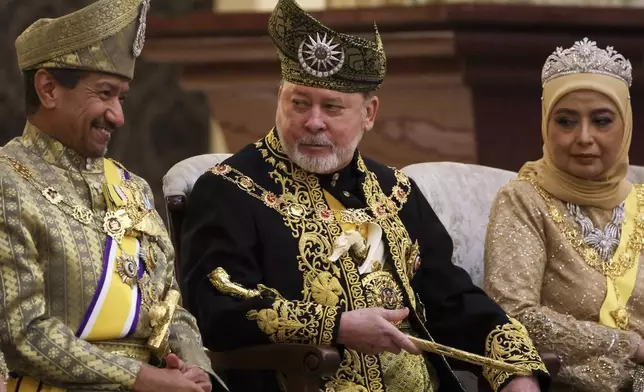 The 17th King of Malaysia, Sultan Ibrahim Iskandar, center, sits with Queen Raja Zarith Sofiah, right, during his coronation at the National Palace in Kuala Lumpur, Malaysia, Saturday, July 20, 2024. (Hasnoor Hussain/Pool Photo via AP)