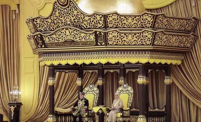 The 17th King of Malaysia, Sultan Ibrahim Iskandar, left, and Queen Raja Zarith Sofiah sit on the thrones during his coronation at the National Palace in Kuala Lumpur, Malaysia, Saturday, July 20, 2024. (Hasnoor Hussain/Pool Photo via AP)