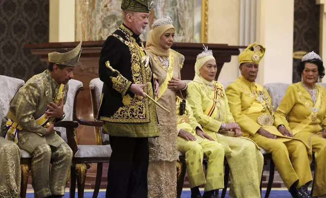 The 17th King of Malaysia, Sultan Ibrahim Iskandar, center left, and Queen Raja Zarith Sofiah, center right, look on during his coronation at the National Palace in Kuala Lumpur, Malaysia, Saturday, July 20, 2024. (Hasnoor Hussain/Pool Photo via AP)