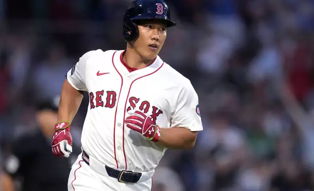 Boston Red Sox's Masataka Yoshida watches the flight of his two-run home run during the third inning of a baseball game against the Seattle Mariners, Monday, July 29, 2024, in Boston. (AP Photo/Charles Krupa)