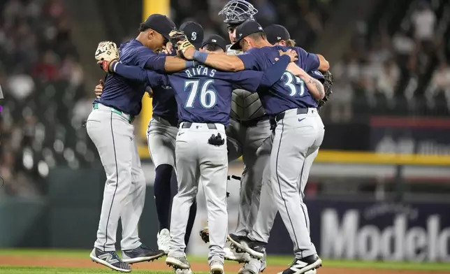 The Seattle Mariners celebrate after their shutout of the Chicago White Sox in a baseball game Friday, July 26, 2024, in Chicago. (AP Photo/Charles Rex Arbogast)