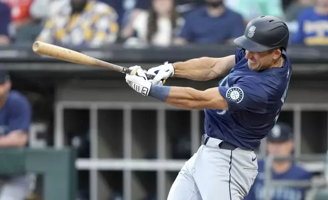 Seattle Mariners' Jason Vosler follows through on a two-run single off Chicago White Sox starting pitcher Drew Thorpe in the first inning of a baseball game Friday, July 26, 2024, in Chicago. (AP Photo/Charles Rex Arbogast)