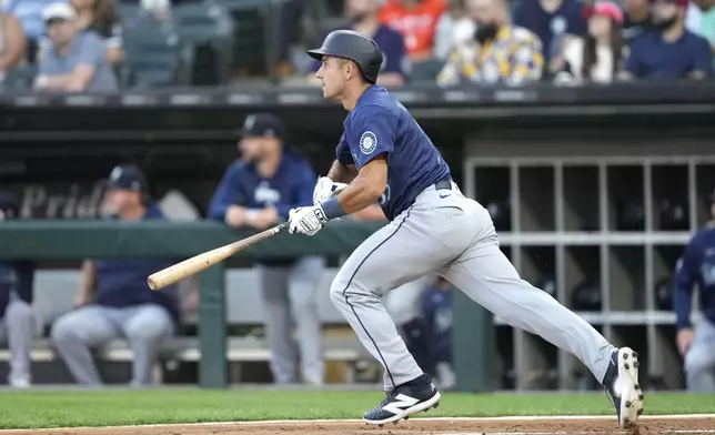 Seattle Mariners' Jason Vosler watches his two-run single off Chicago White Sox starting pitcher Drew Thorpe in the first inning of a baseball game Friday, July 26, 2024, in Chicago. (AP Photo/Charles Rex Arbogast)