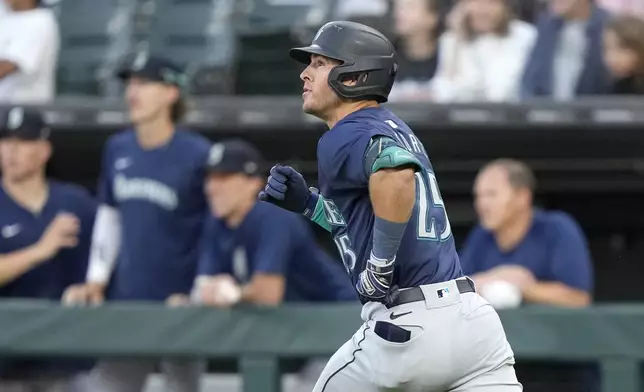 Seattle Mariners' Dylan Moore watches his home run off Chicago White Sox starting pitcher Drew Thorpe during the first inning of a baseball game Friday, July 26, 2024, in Chicago. (AP Photo/Charles Rex Arbogast)