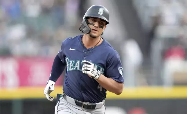 Seattle Mariners' Josh Rojas rounds the bases after his three-run home run off Chicago White Sox starting pitcher Drew Thorpe in the first inning of a baseball game Friday, July 26, 2024, in Chicago. (AP Photo/Charles Rex Arbogast)