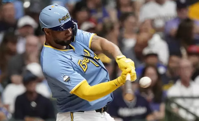 Milwaukee Brewers' Gary Sánchez hits an RBI sacrifice fly during the fourth inning of a baseball game against the Miami Marlins, Friday, July 26, 2024, in Milwaukee. (AP Photo/Aaron Gash)