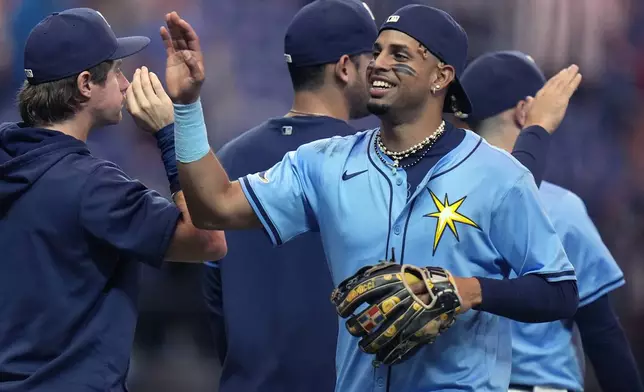 Tampa Bay Rays' Christopher Morel celebrates with teammates after the team defeated the Miami Marlins during a baseball game Tuesday, July 30, 2024, in St. Petersburg, Fla. (AP Photo/Christopher O'Meara)