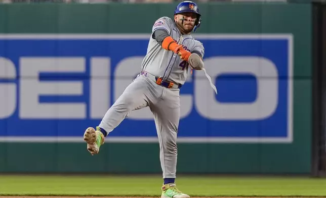 New York Mets' Francisco Alvarez celebrates his two-RBI double during the sixth inning of a baseball game against the Washington Nationals at Nationals Park, Monday, July 1, 2024, in Washington. (AP Photo/Alex Brandon)
