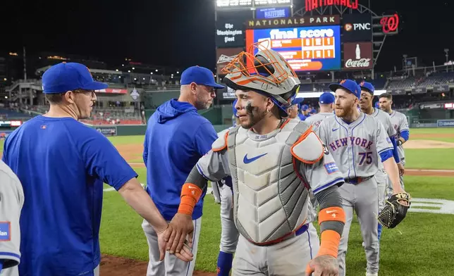 New York Mets catcher Francisco Alvarez, front right, and teammates celebrate after a baseball game against the Washington Nationals at Nationals Park, Monday, July 1, 2024, in Washington. (AP Photo/Alex Brandon)