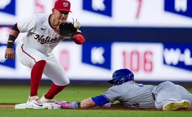 New York Mets' Harrison Bader, right, steals second as Washington Nationals second baseman Ildemaro Vargas waits for the throw during the sixth inning of a baseball game at Nationals Park, Monday, July 1, 2024, in Washington. (AP Photo/Alex Brandon)