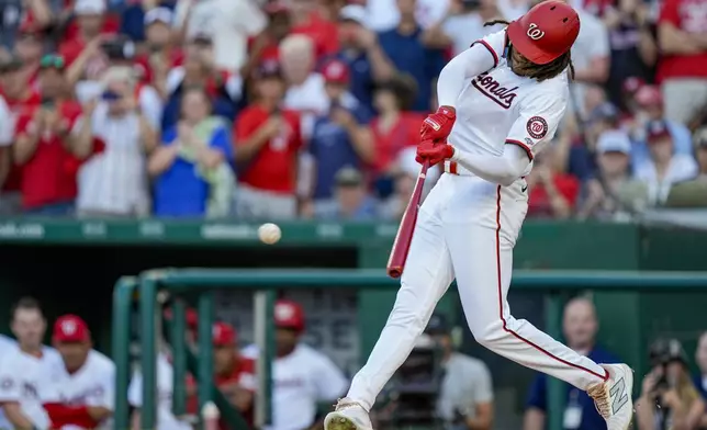 Washington Nationals' James Wood hits a single in his first major league at-bat during the second inning of a baseball game against the New York Mets at Nationals Park, Monday, July 1, 2024, in Washington. (AP Photo/Alex Brandon)