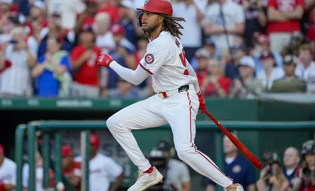 Washington Nationals' James Wood drops his bat as he hits a single in his first major league at-bat during the second inning of a baseball game against the New York Mets at Nationals Park, Monday, July 1, 2024, in Washington. (AP Photo/Alex Brandon)