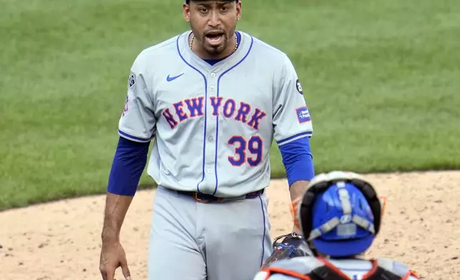 New York Mets relief pitcher Edwin Diaz (39) celebrates with catcher Francisco Alvarez, bottom, after getting the final out of a baseball game against the Pittsburgh Pirates in Pittsburgh, Saturday, July 6, 2024. (AP Photo/Gene J. Puskar)